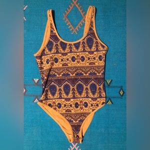 Super cute Free People body suit with snaps.